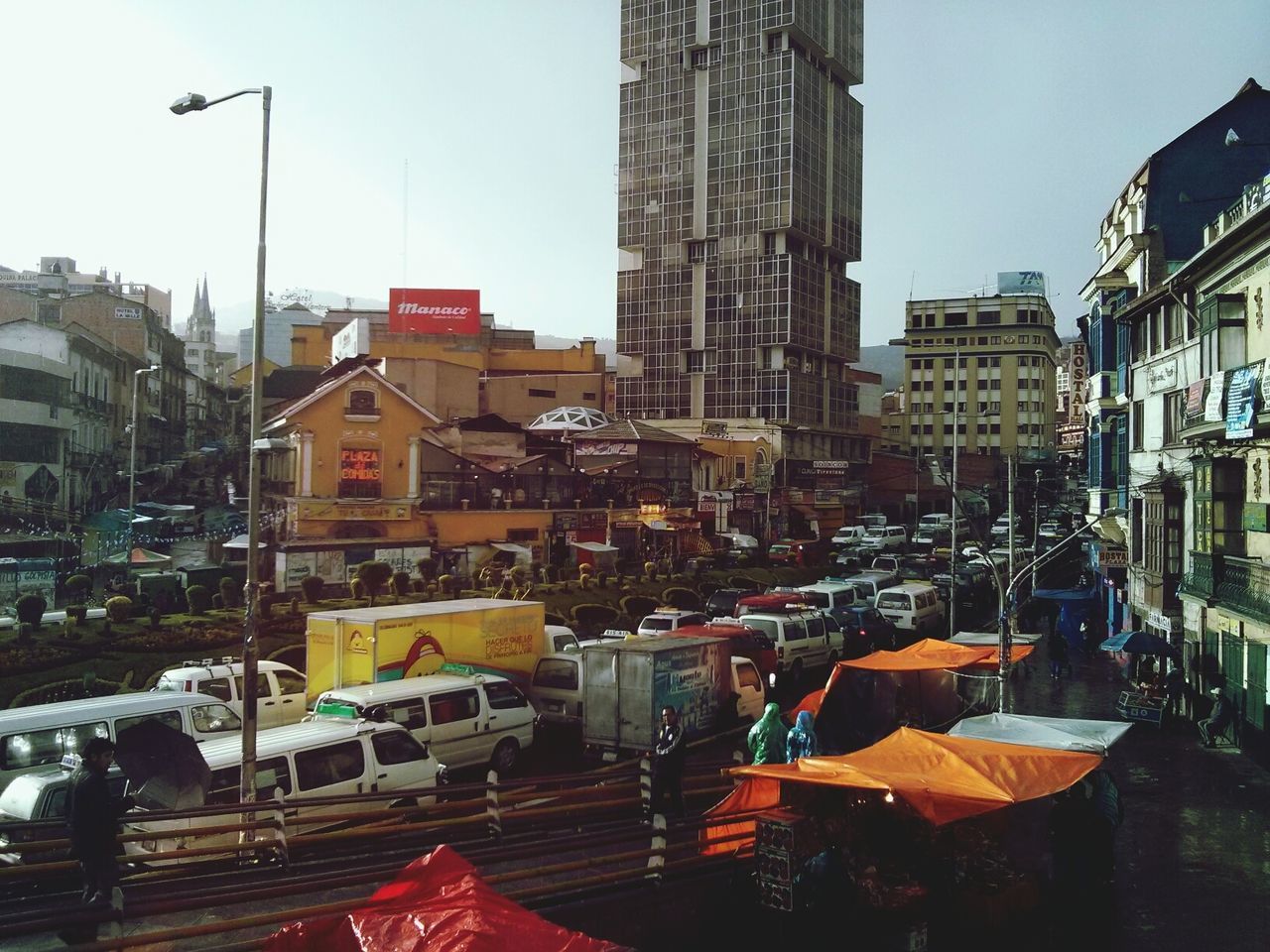 Vehicles on city street against buildings