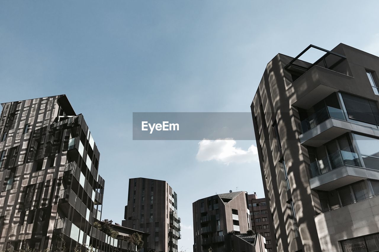 LOW ANGLE VIEW OF OFFICE BUILDINGS AGAINST SKY