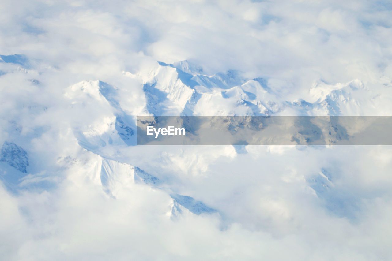 Scenic view of snow covered mountains against sky