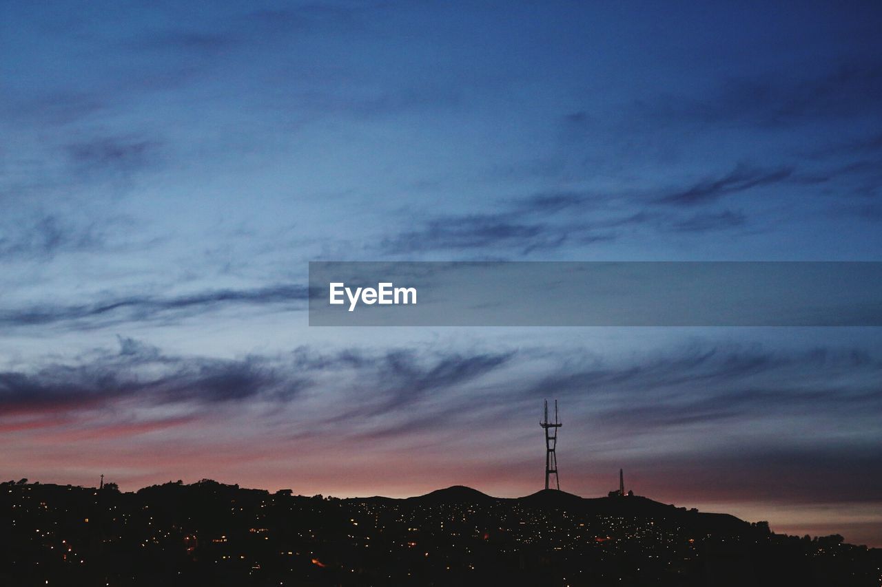 Mountains against cloudy sky at dusk