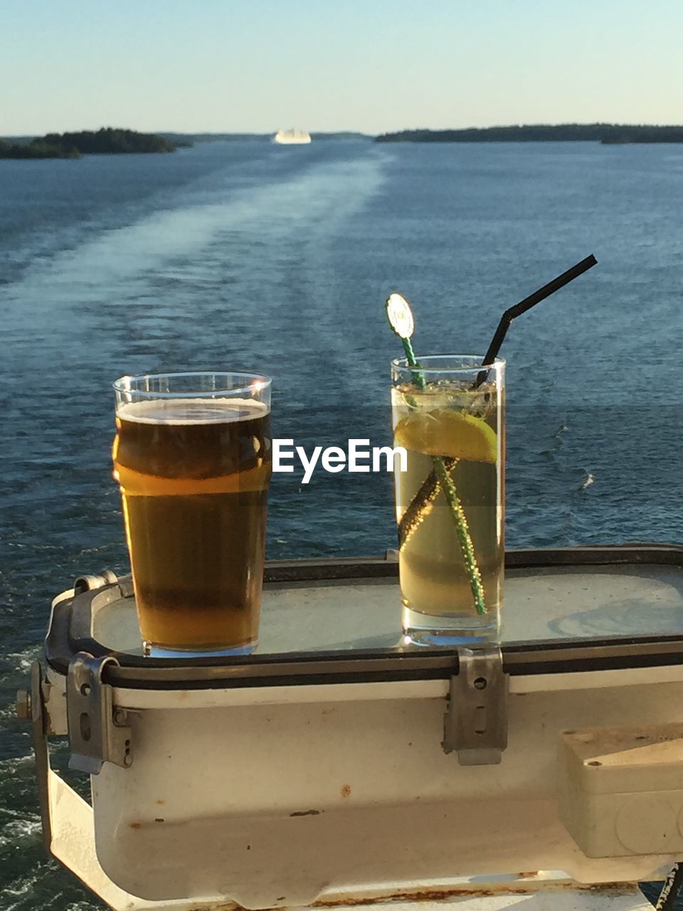 Fresh drink served on tray in boat over sea