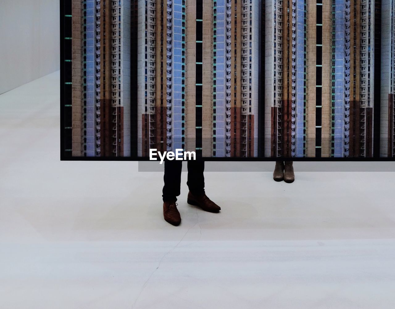 LOW SECTION OF MAN STANDING ON FLOOR IN CURTAIN