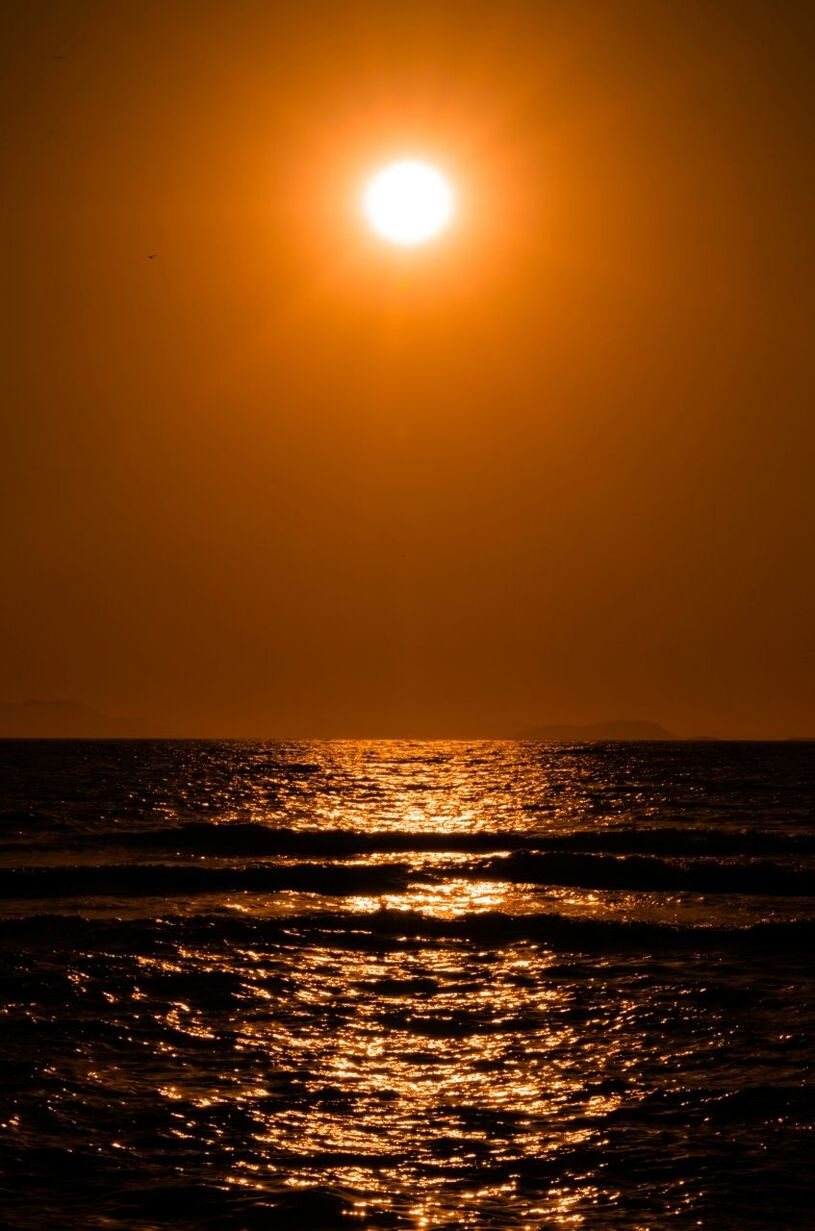 View of calm sea at sunset