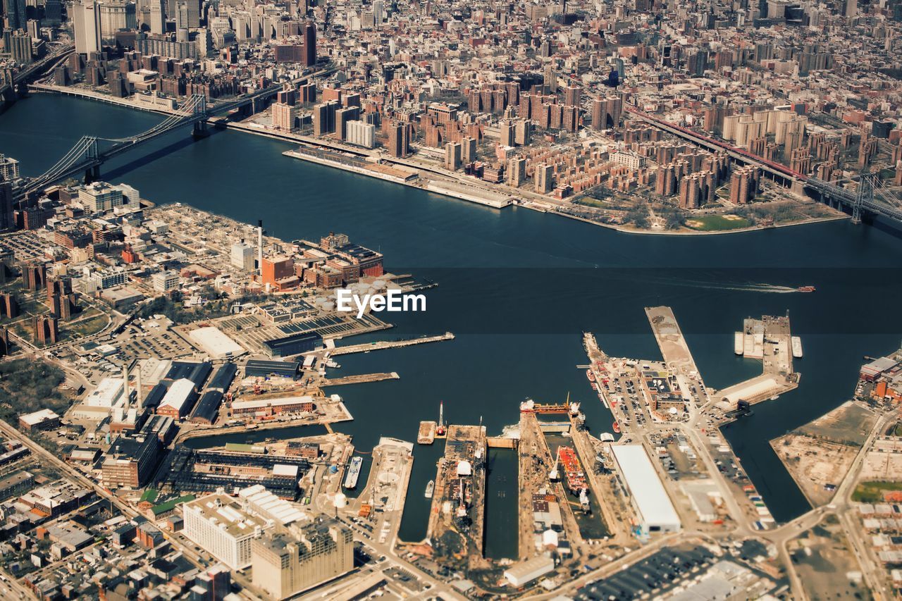 Aerial view of east river amidst cityscape