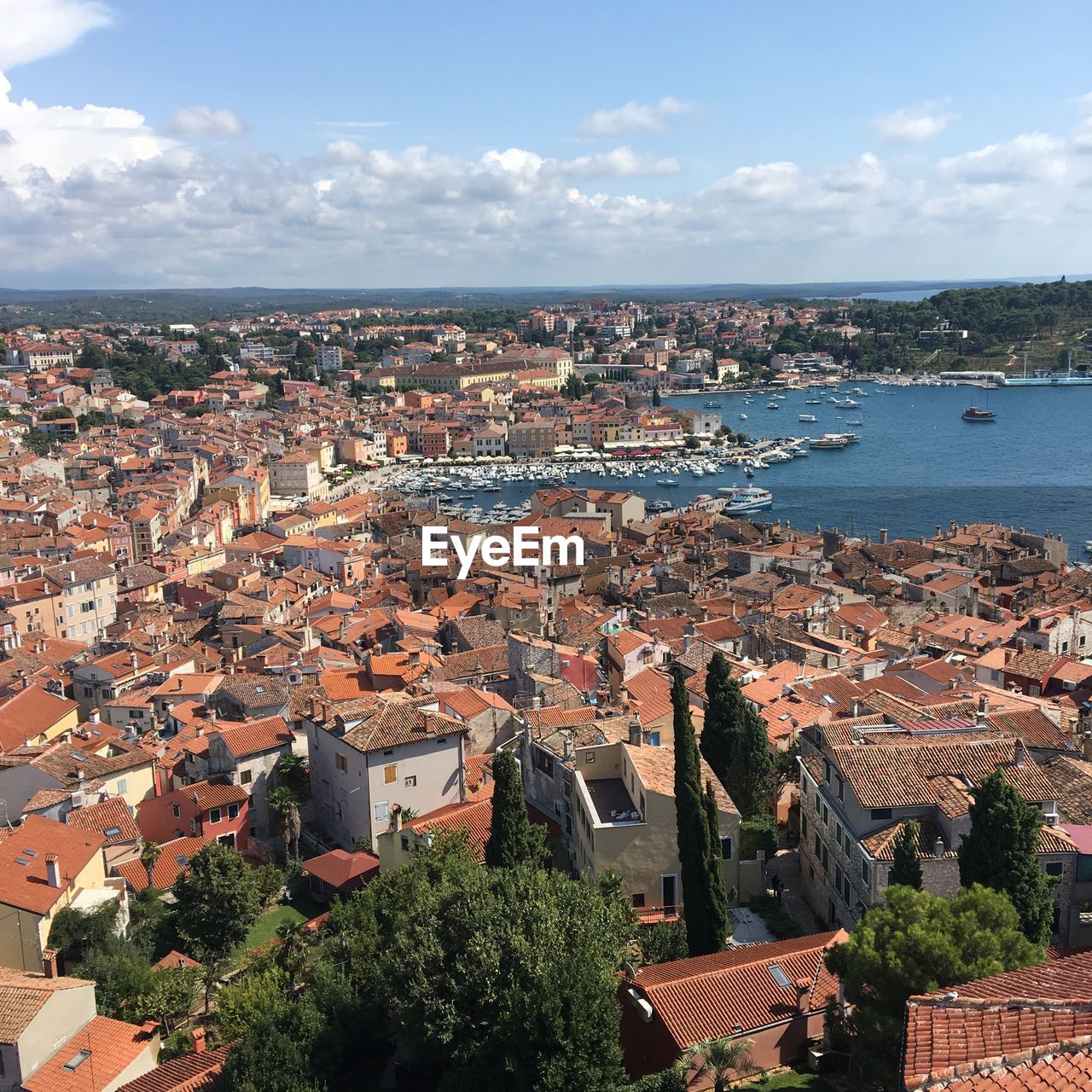 High angle view of townscape by sea against sky