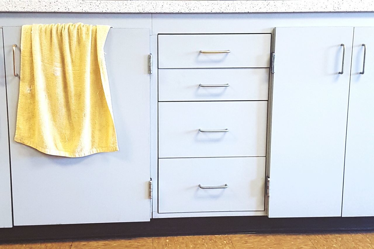 Towel hanging on cabinet at home