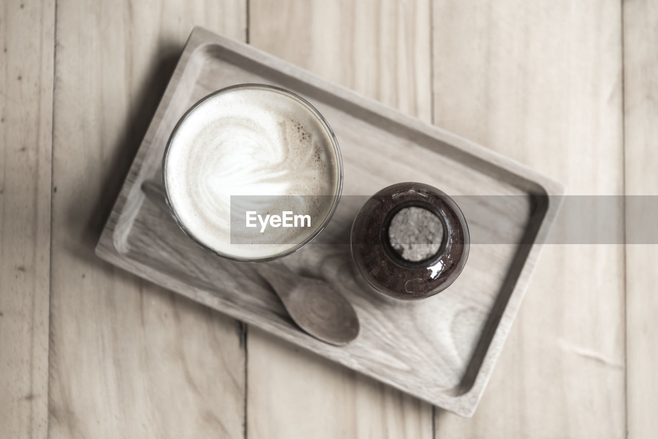 HIGH ANGLE VIEW OF COFFEE ON WOODEN TABLE