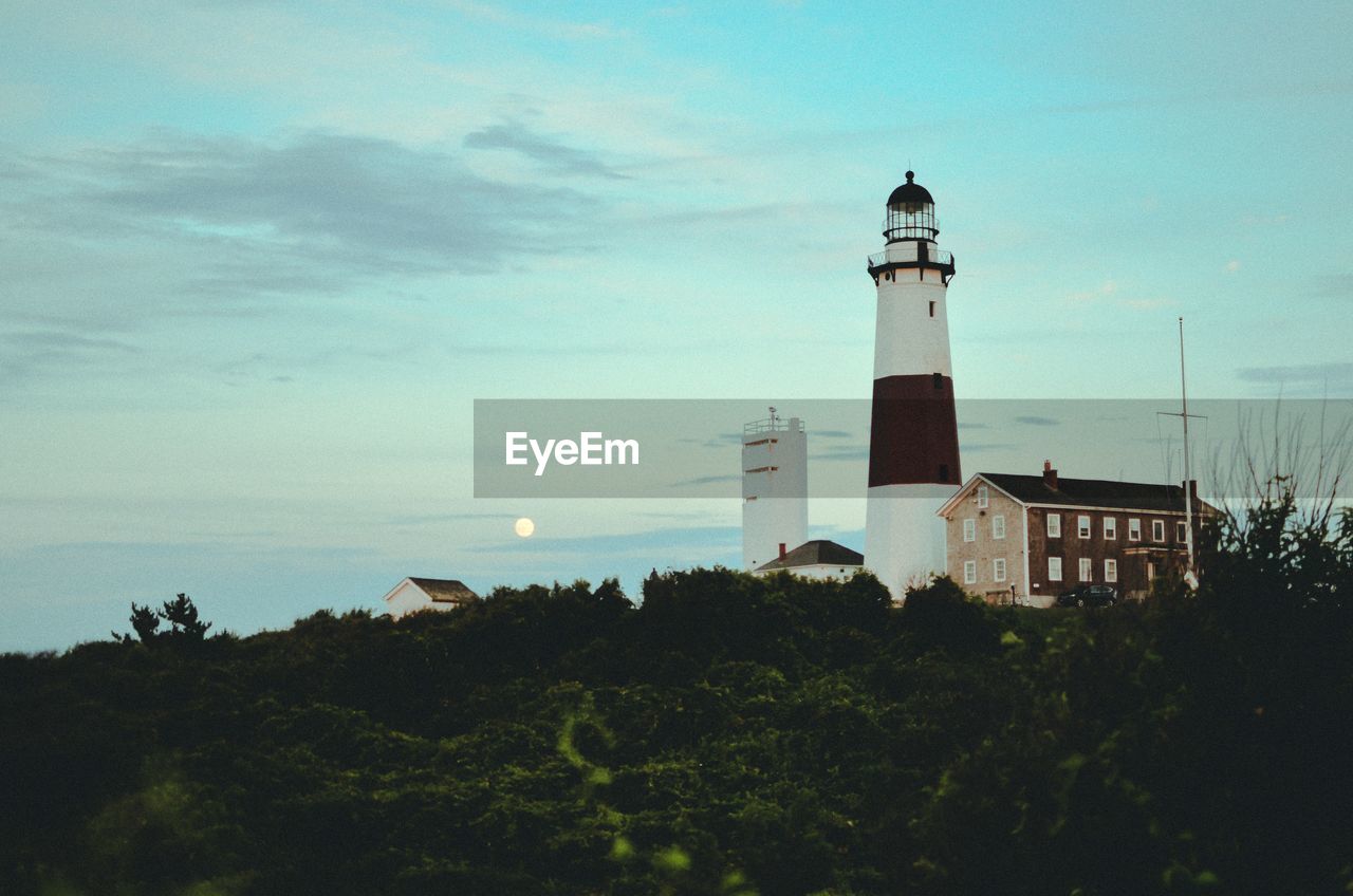 LIGHTHOUSE ON SEA AGAINST SKY