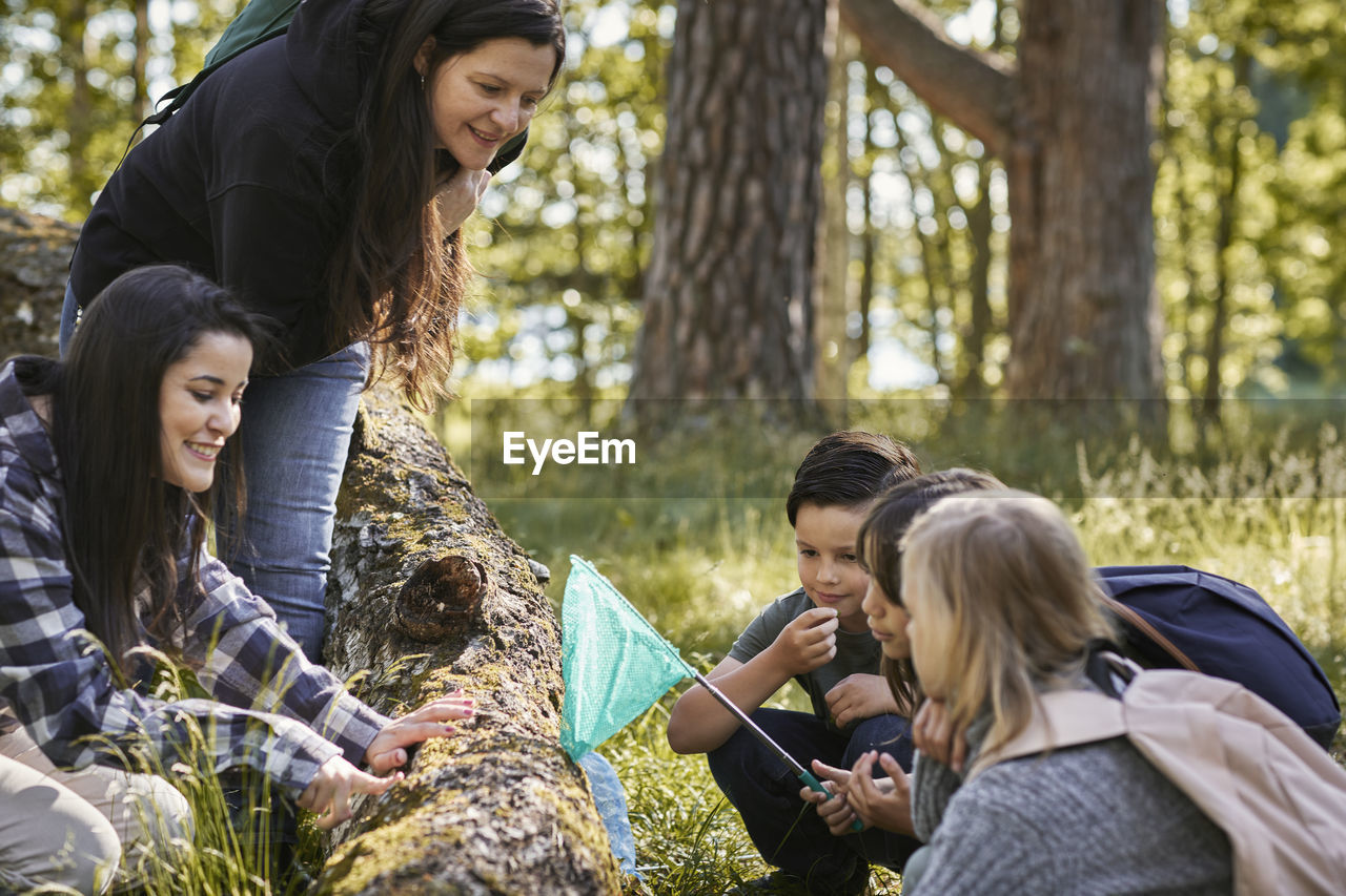 Family with children walking in forest