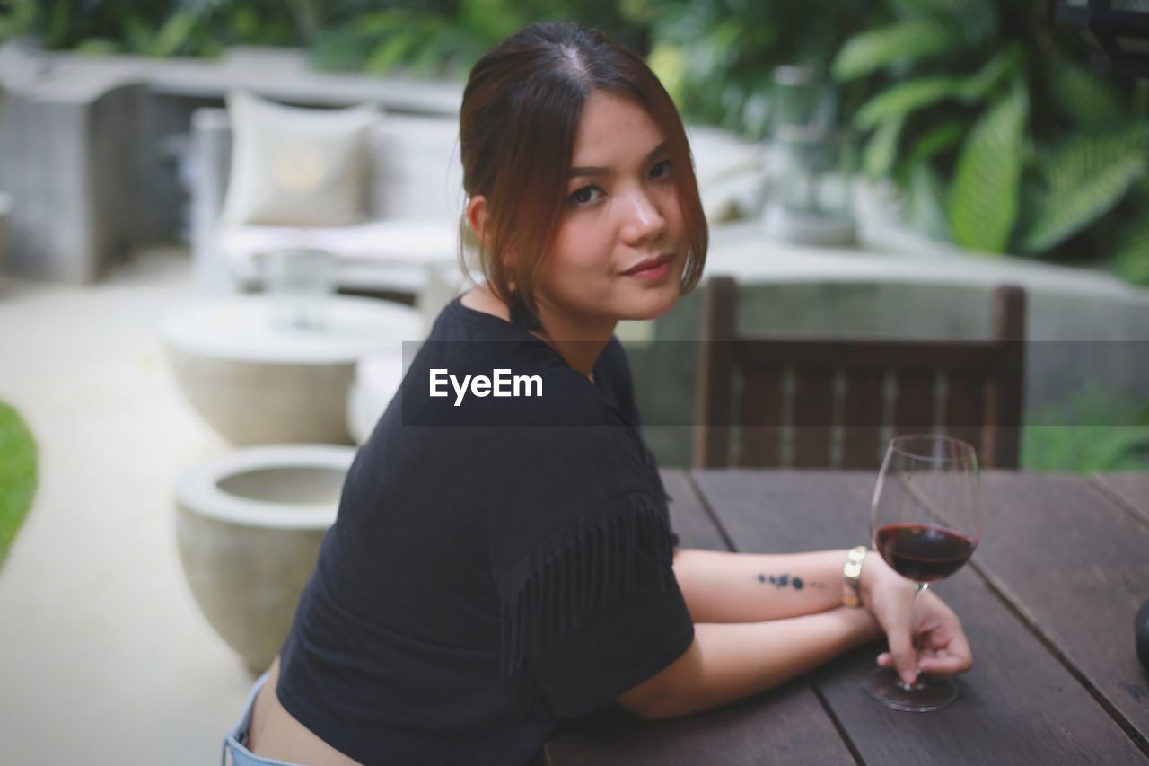 Portrait of young woman sitting at cafe