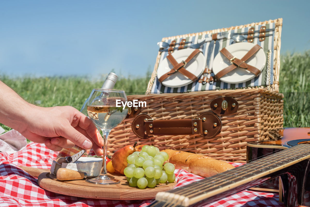 Closeup of picnic basket with drinks and food on the grass. nice picnic on sunny summer day, fun