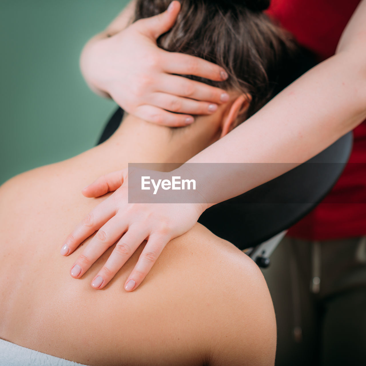 Chair massage. therapist massaging womans neck, stress and tension relief