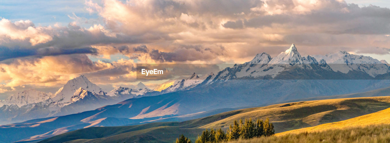 Scenic view of mountains against cloudy sky