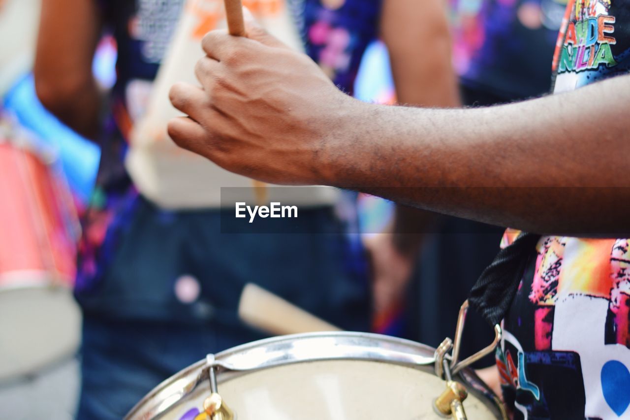 Close-up of man playing drum