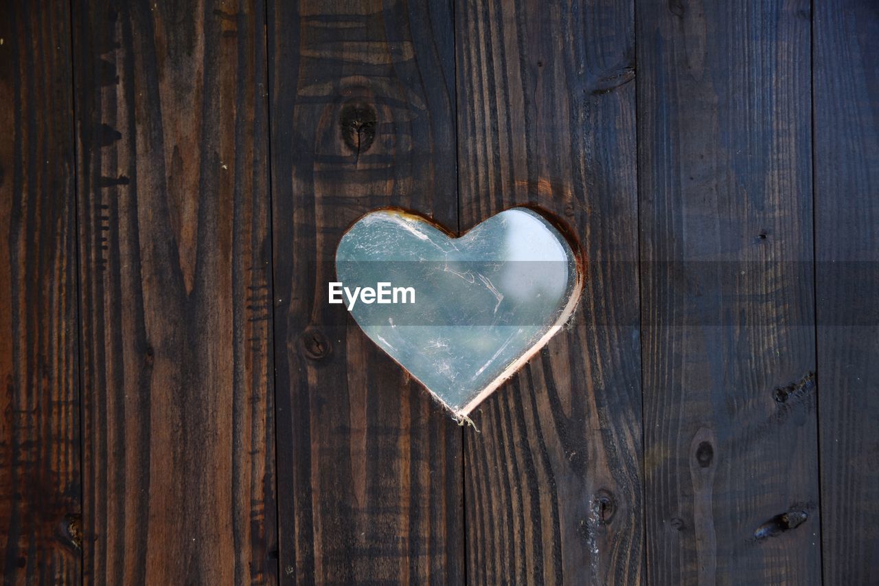 Close-up of heart shape on wooden wall