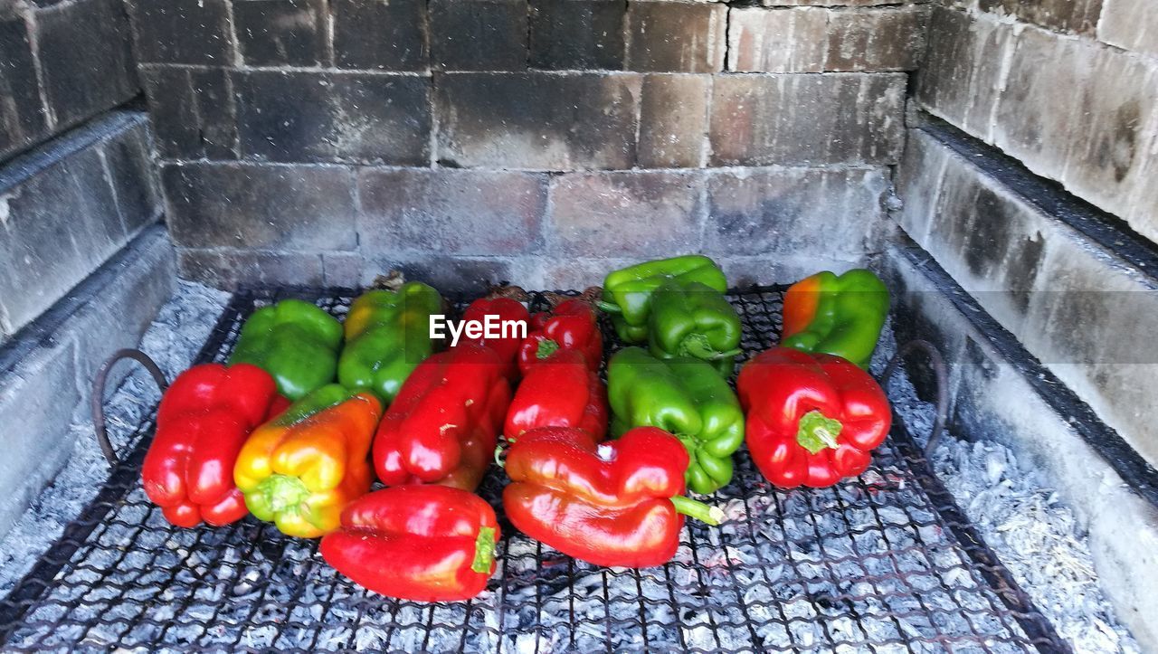 HIGH ANGLE VIEW OF TOMATOES AND VEGETABLES ON GRILL