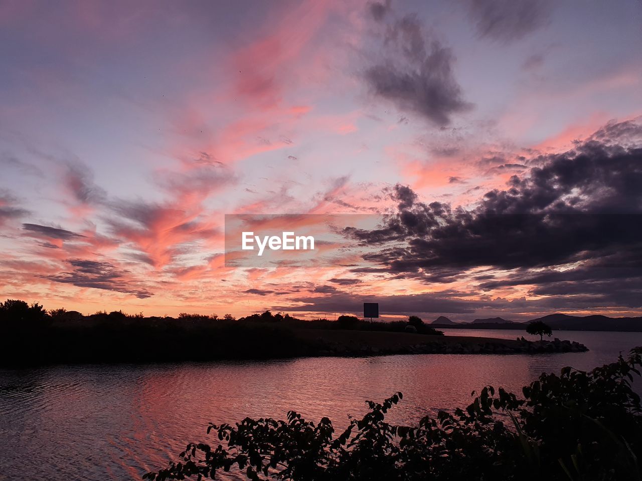 Scenic view of lake against sky during sunset