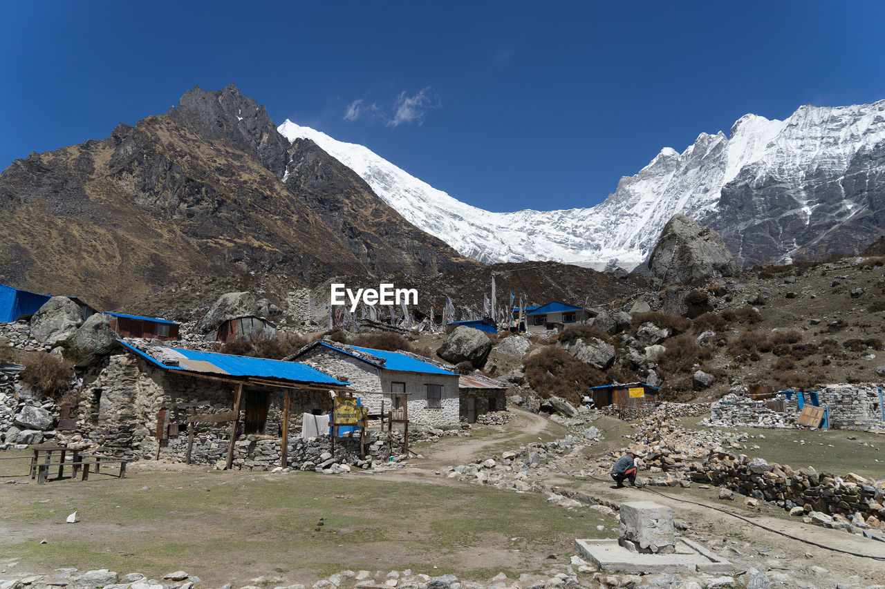 Scenic view of snowcapped mountains against blue sky