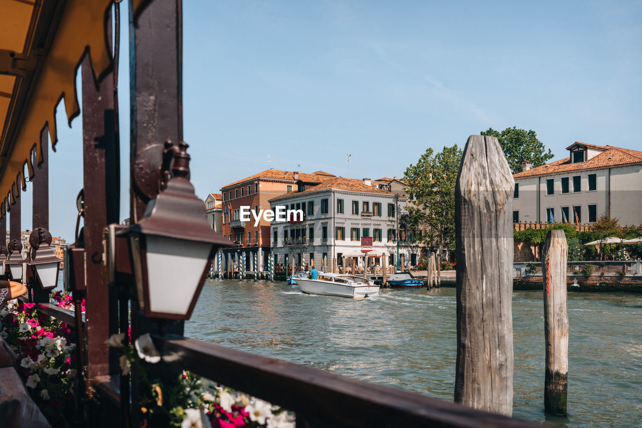 View from a waterside restaurant of a water taxi riding through grand canal in venice, italy.