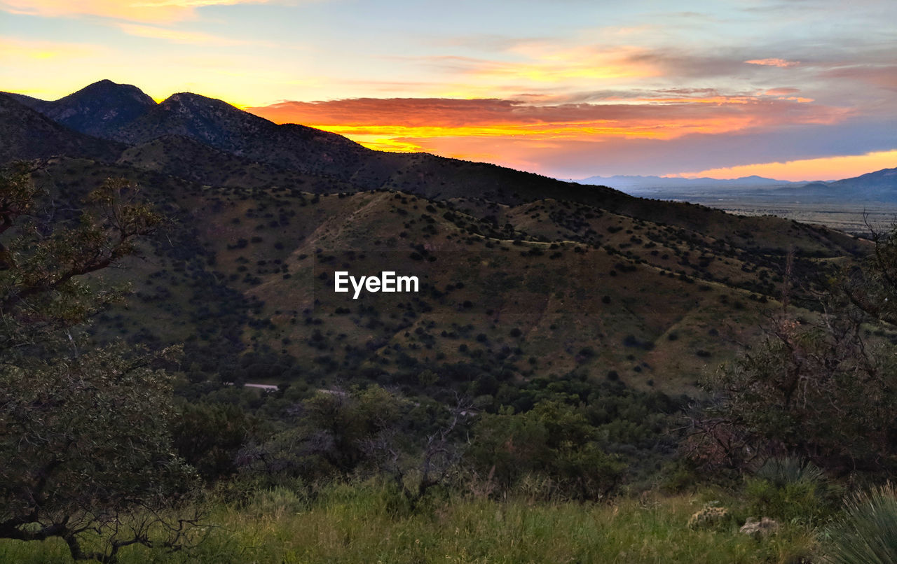 SCENIC VIEW OF LANDSCAPE AGAINST SKY DURING SUNSET