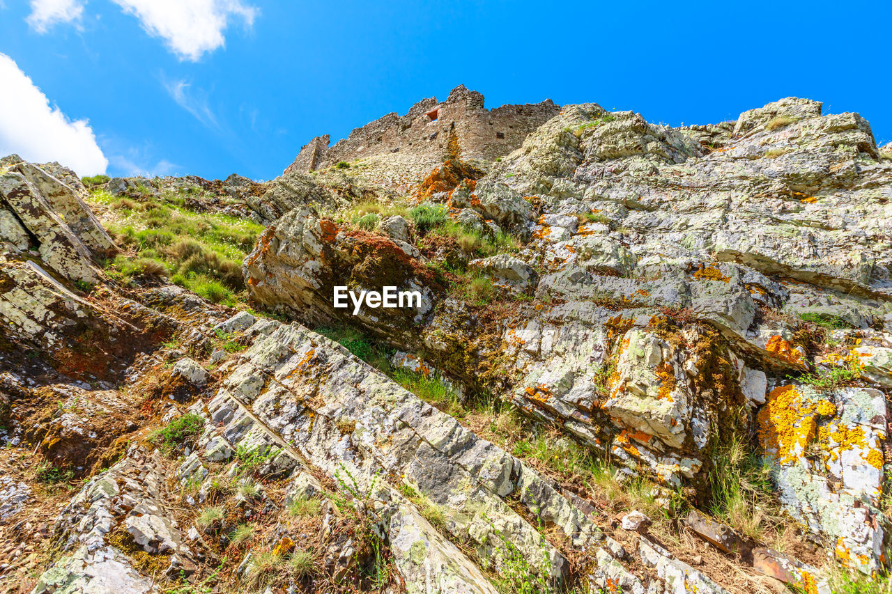 LOW ANGLE VIEW OF ROCK FORMATIONS AGAINST SKY