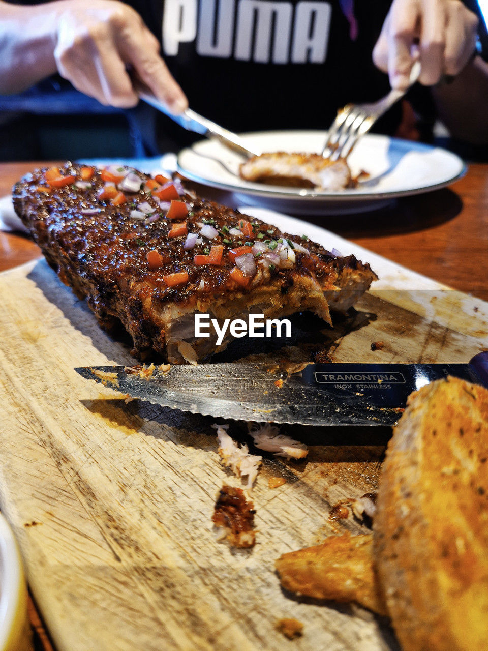 food, food and drink, dish, freshness, hand, meat, grilling, meal, roasted, table, indoors, healthy eating, cuisine, one person, wellbeing, fast food, eating utensil, cooking, dinner, eating, kitchen utensil, close-up, wood, adult, baked, kitchen knife, selective focus, barbecue, plate