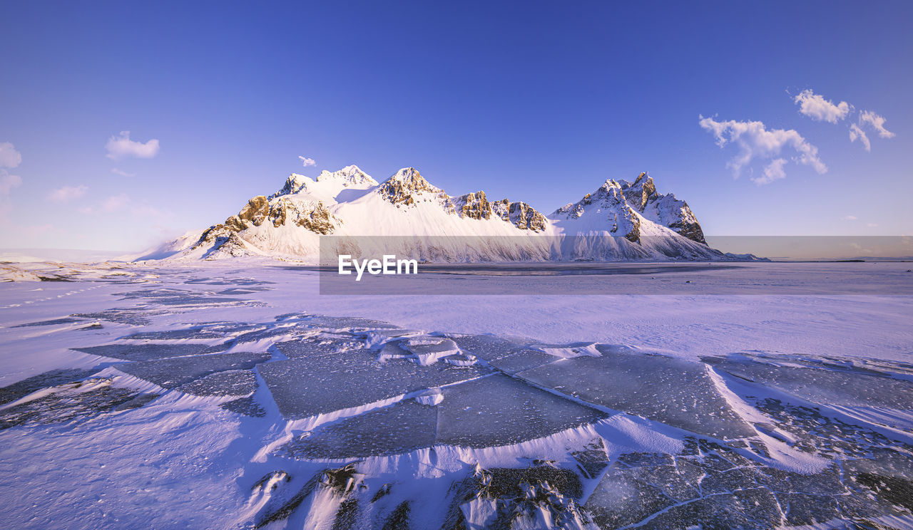 Scenic view of snowcapped landscape against sky during winter