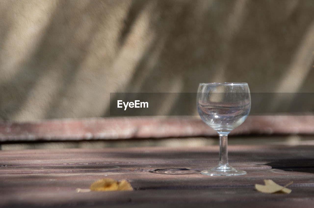 glass, food and drink, refreshment, drink, alcohol, wine, wine glass, wood, household equipment, drinking glass, no people, table, food, freshness, alcoholic beverage, still life photography, selective focus, nature, close-up, stemware, tableware, day, outdoors, still life, focus on foreground