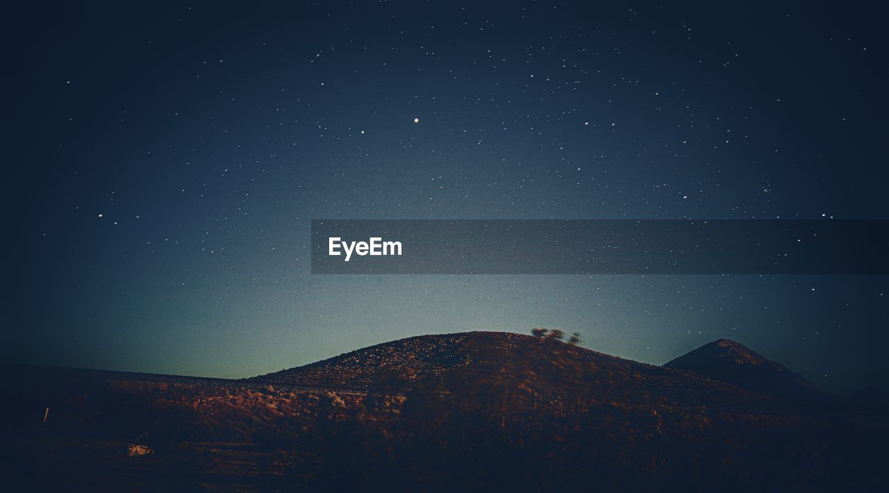 LOW ANGLE VIEW OF STAR FIELD AGAINST SKY AT NIGHT