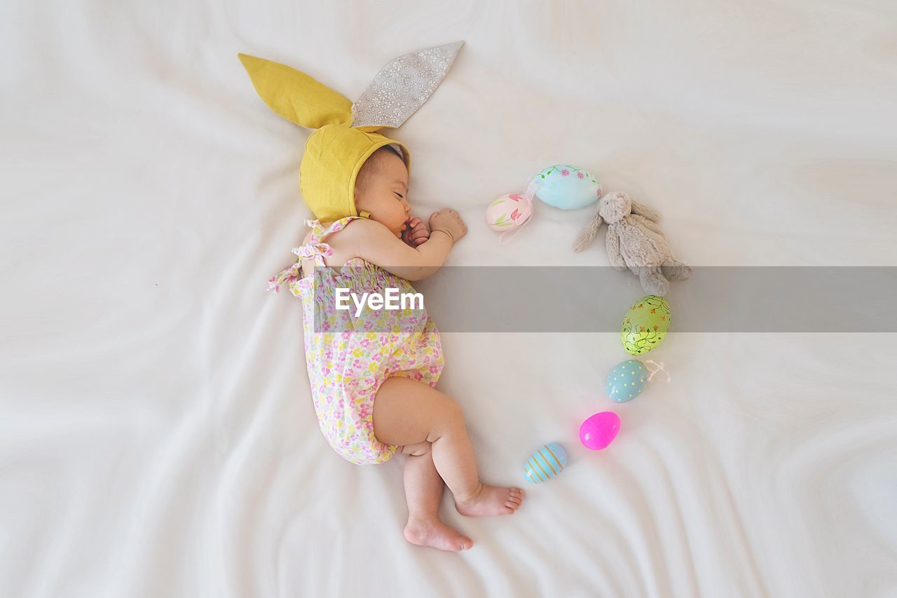 high angle view of baby boy sleeping on bed