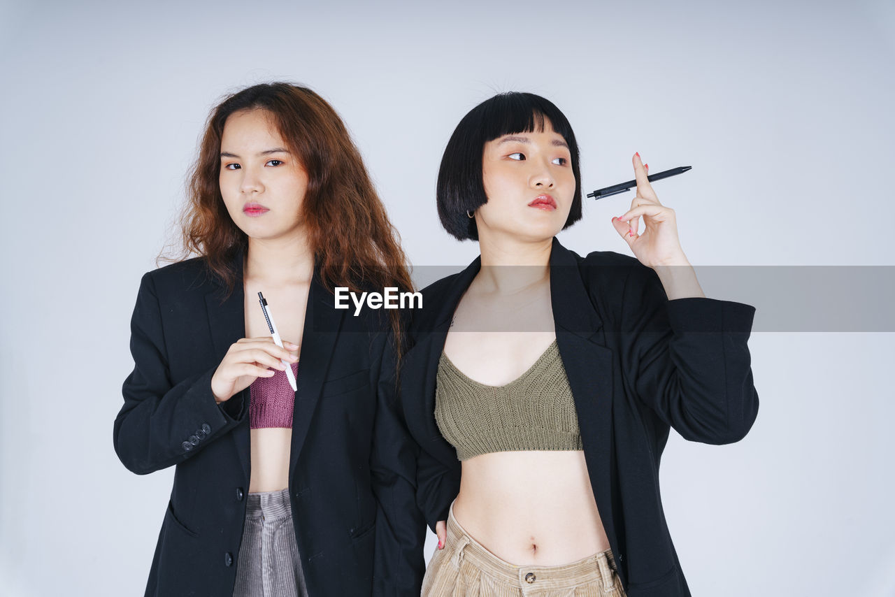 Lesbian couple standing against white background