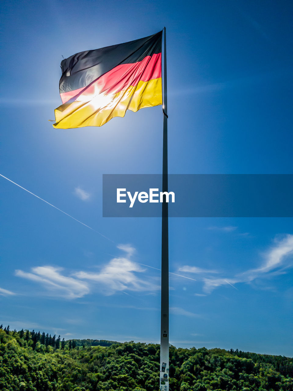 LOW ANGLE VIEW OF FLAG FLAGS AGAINST BLUE SKY