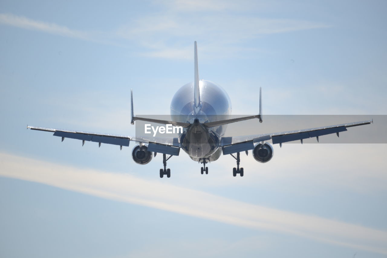 Low angle view of airplane flying against sky