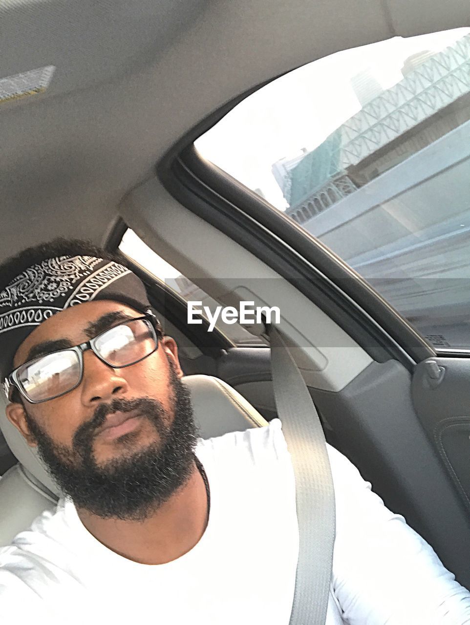 PORTRAIT OF YOUNG MAN IN CAR