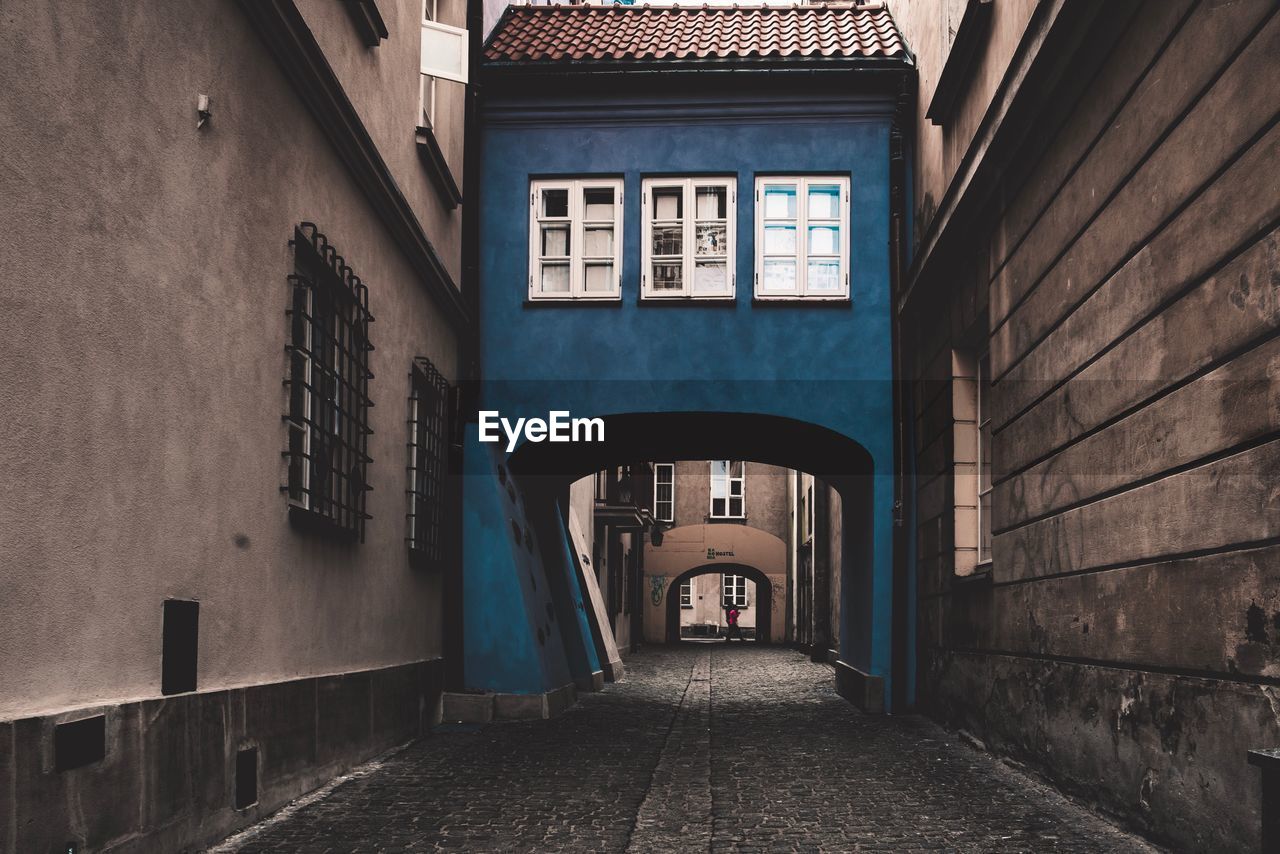 Empty alley amidst buildings in city