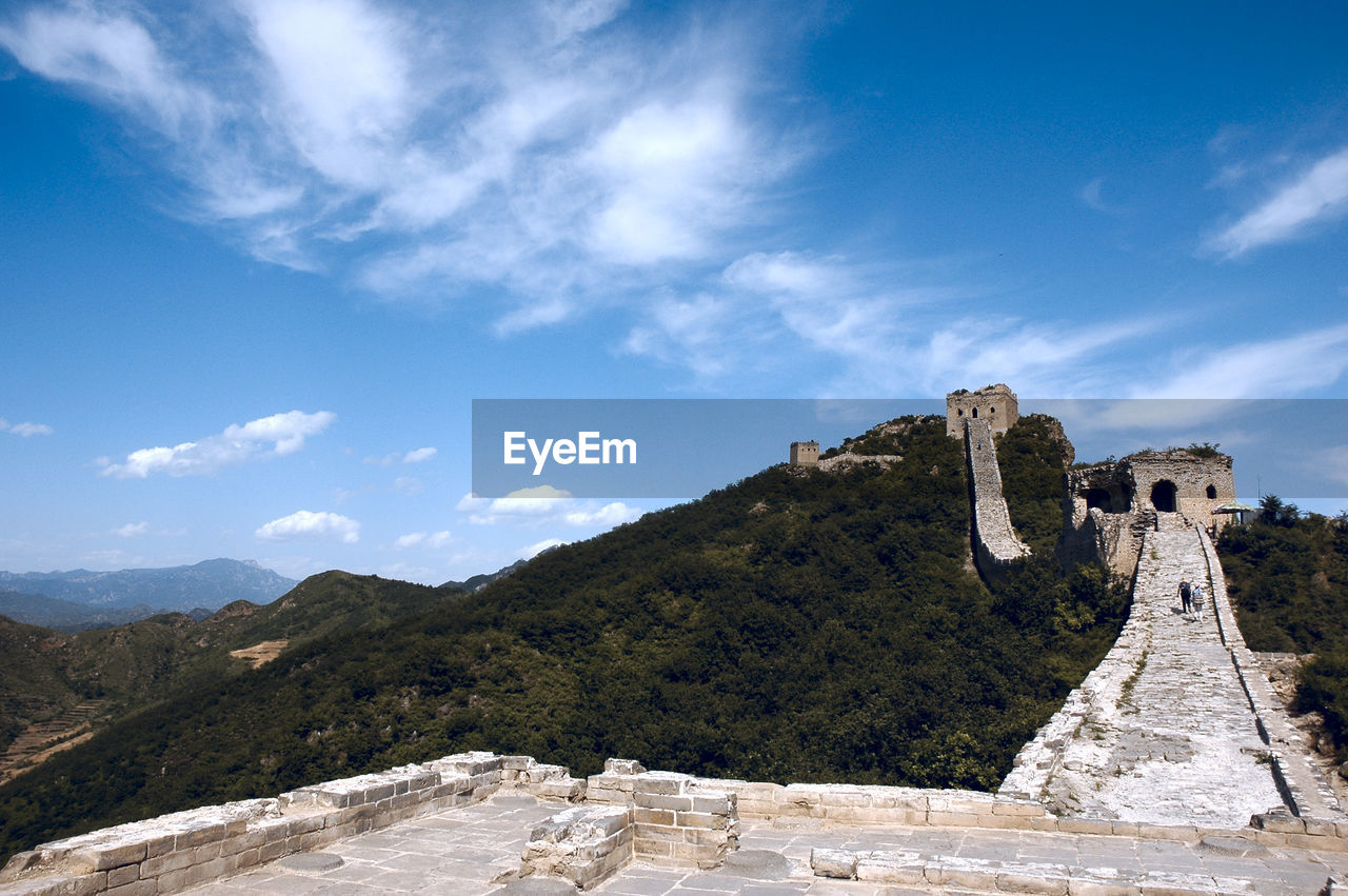 Scenic view of mountains against cloudy sky