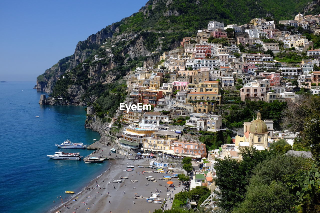 Houses in sea shore at positano against clear sky