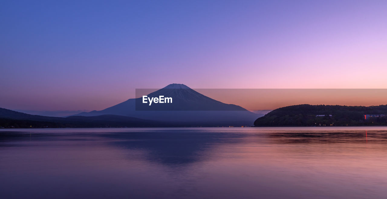 Scenic view of sea against clear sky at sunset