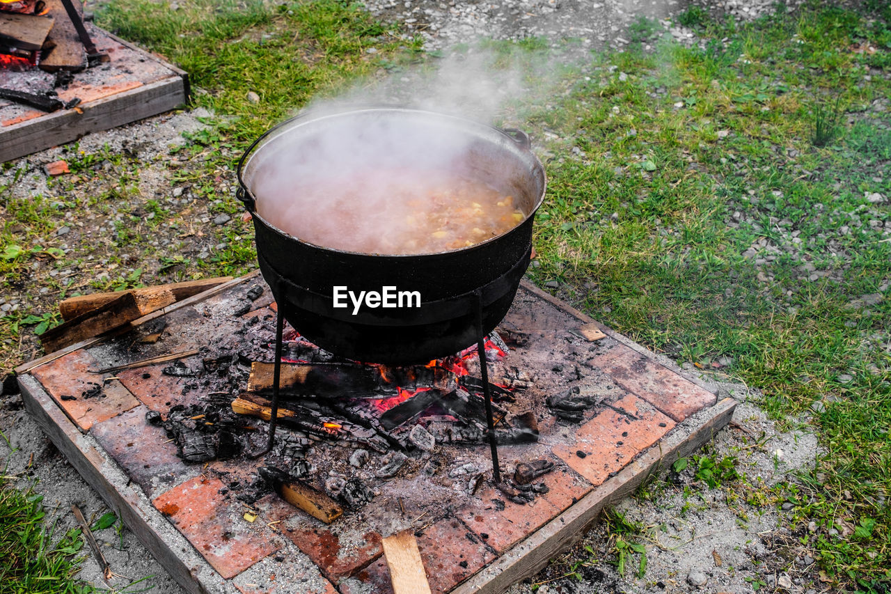 HIGH ANGLE VIEW OF FIRE ON BARBECUE