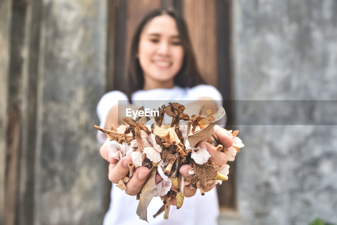 Side view of woman holding flower bouquet