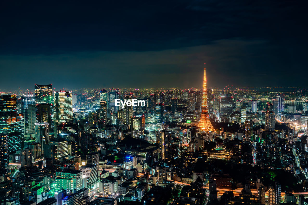 Illuminated cityscape against sky at night