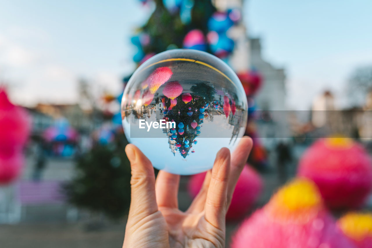 Close-up of hand holding crystal ball