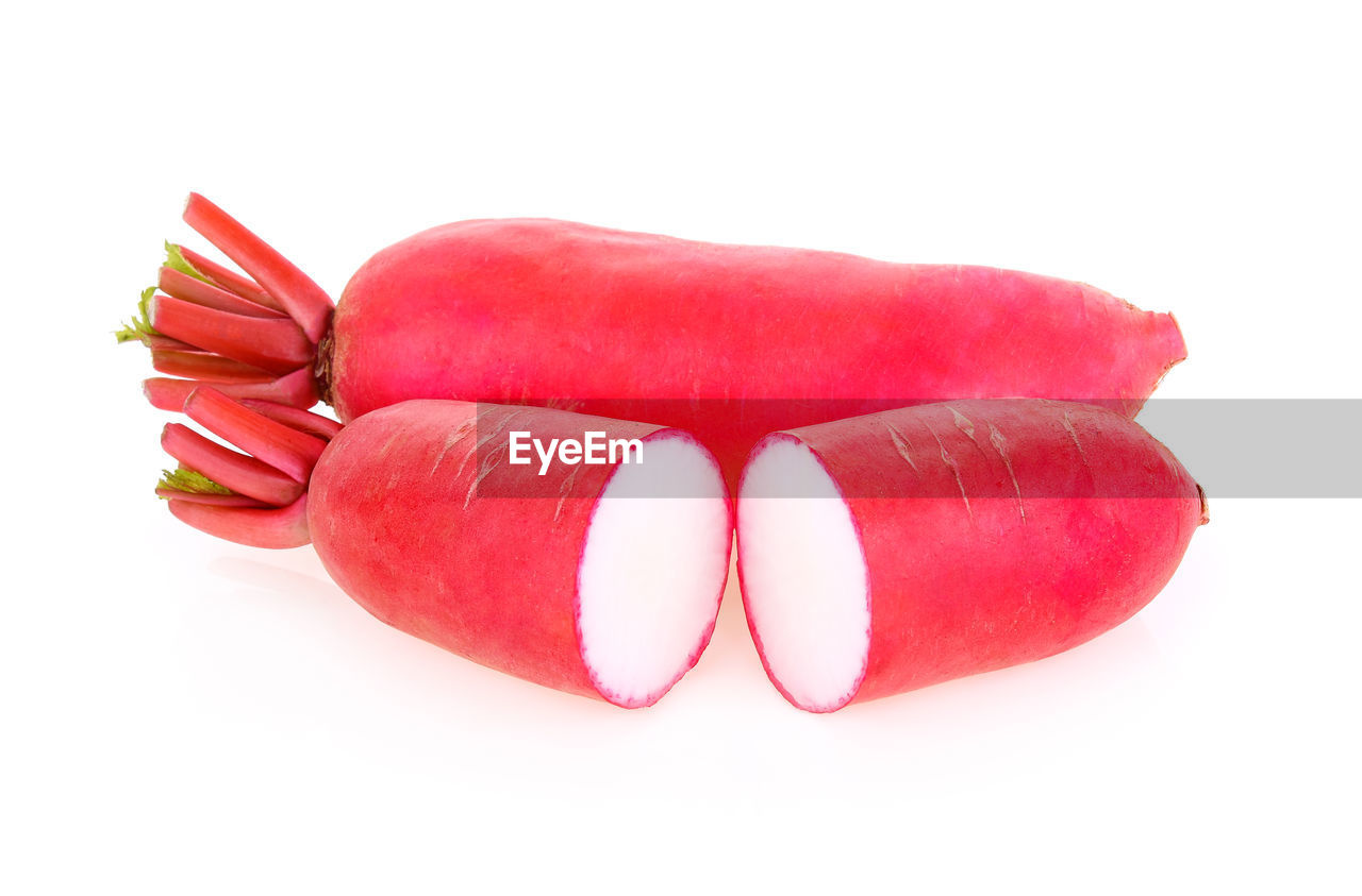 CLOSE-UP OF RED CHILI OVER WHITE BACKGROUND