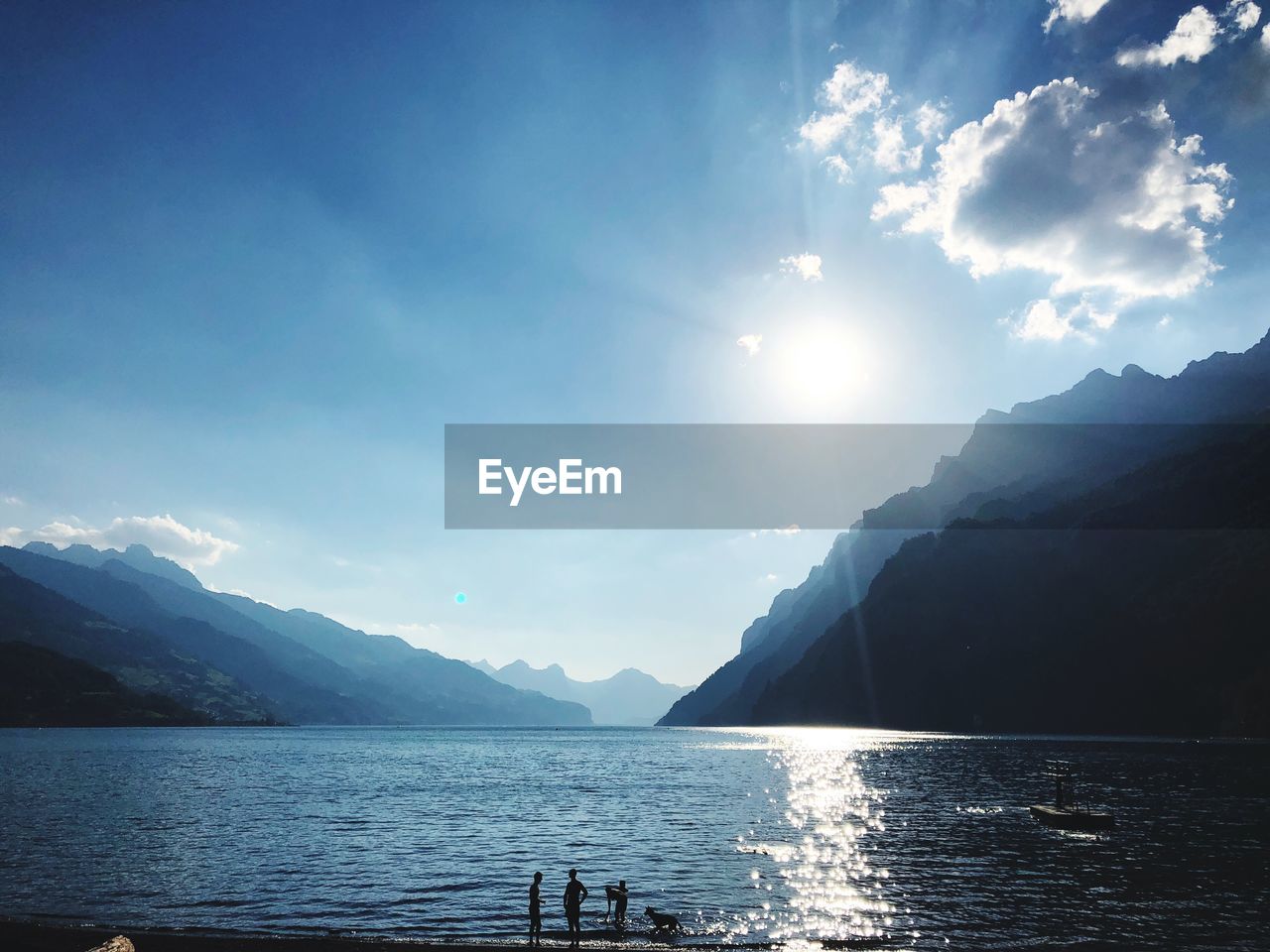 Scenic view of sea and mountains against sky