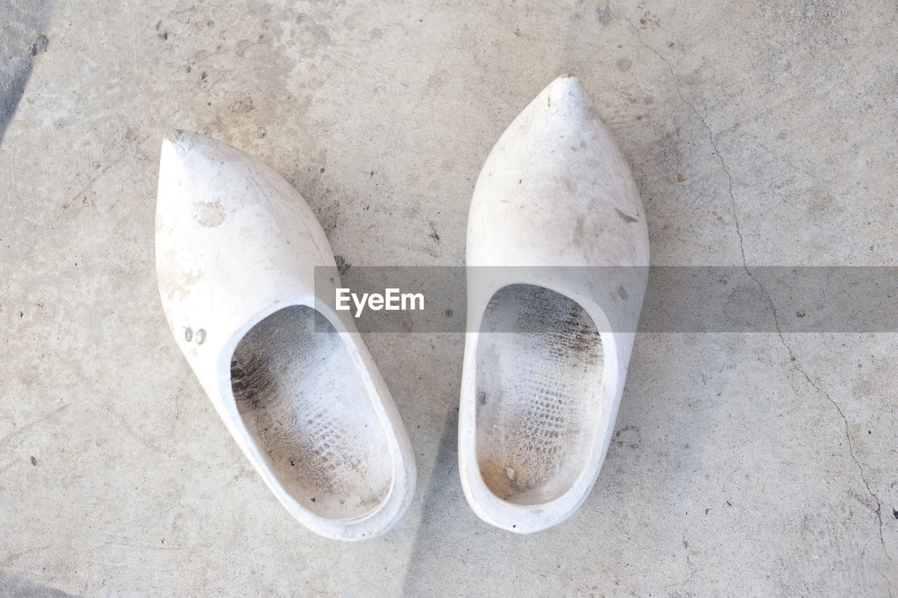 Directly above shot of old wooden clogs on floor