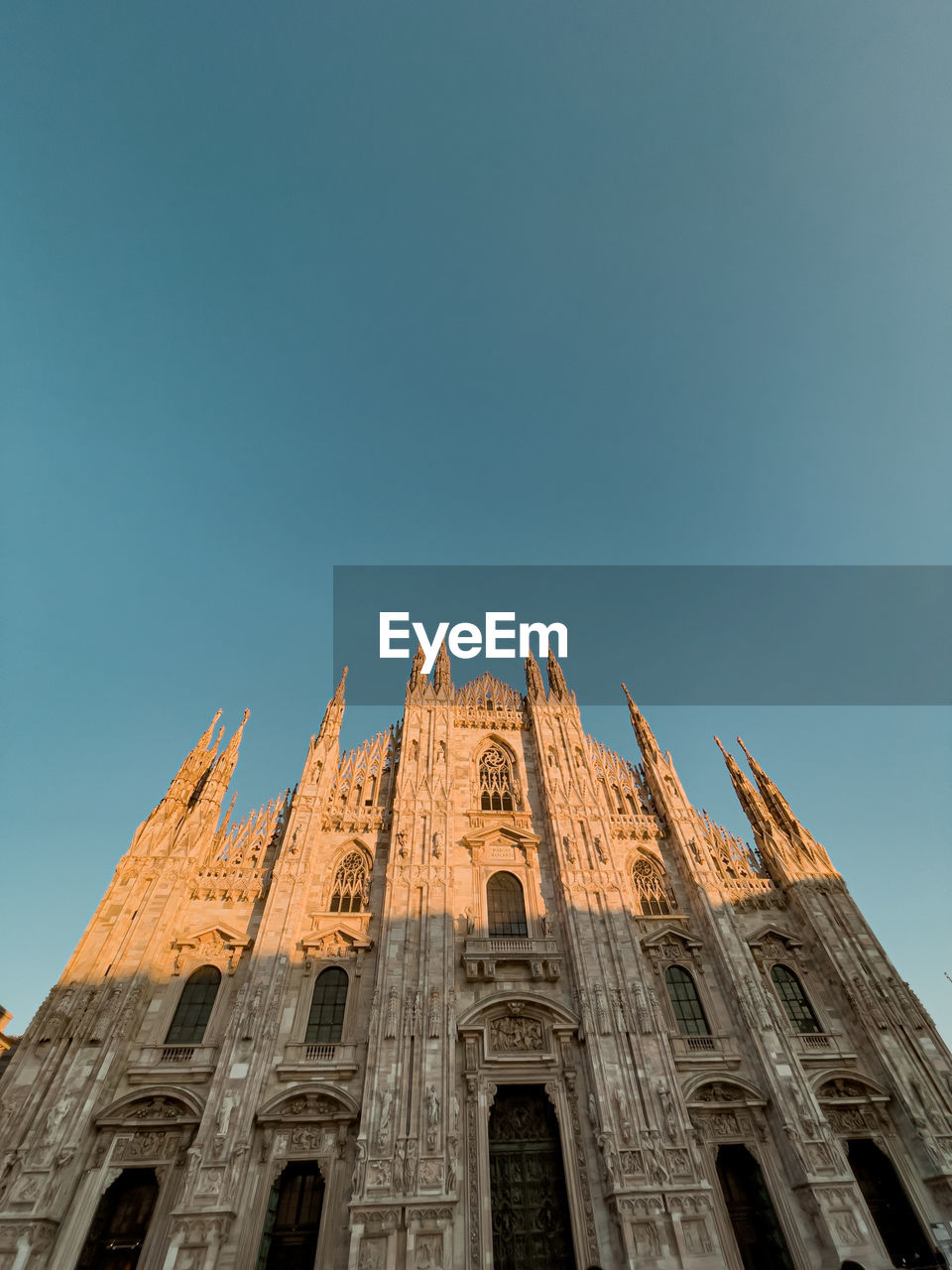 Low angle view of building against clear blue sky