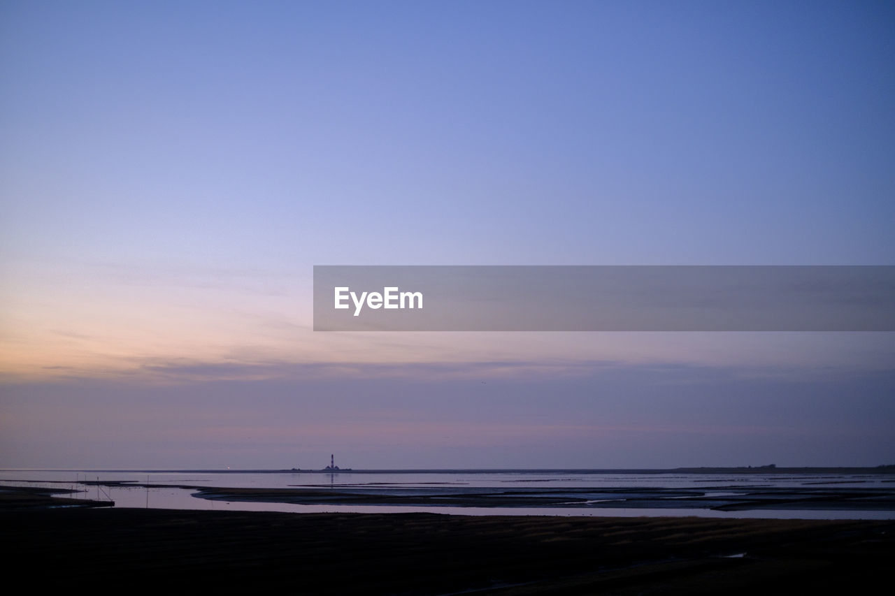 Scenic view of beach against sky during sunset