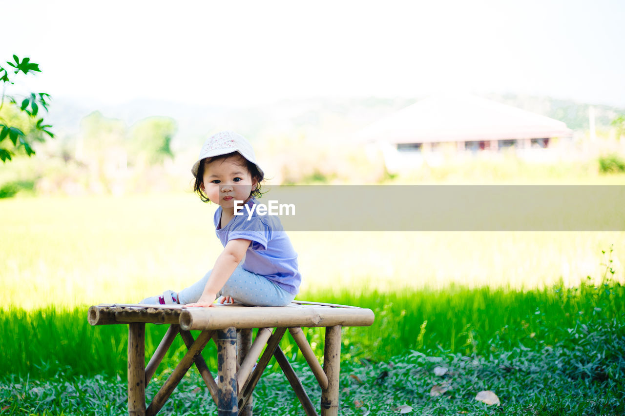 PORTRAIT OF CUTE BOY IN FIELD