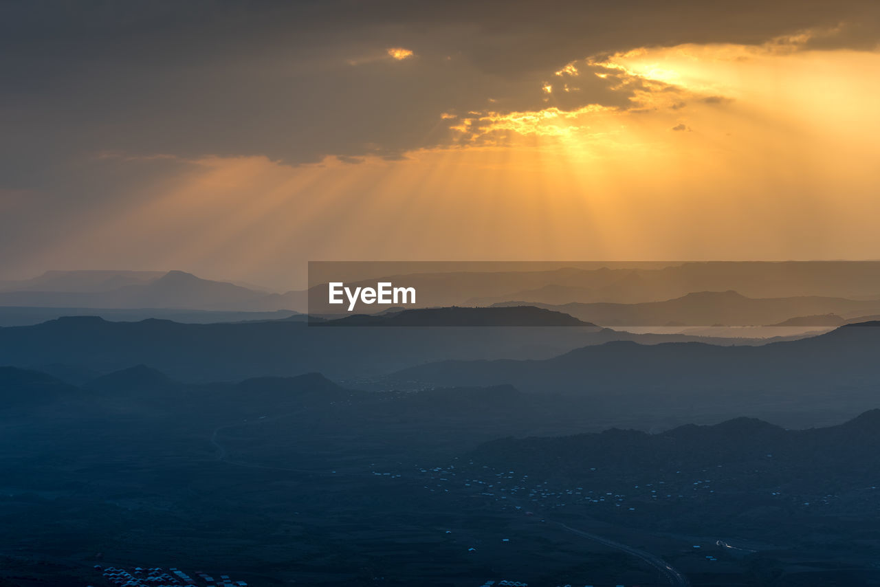 Scenic view of silhouette mountains against sky during sunset