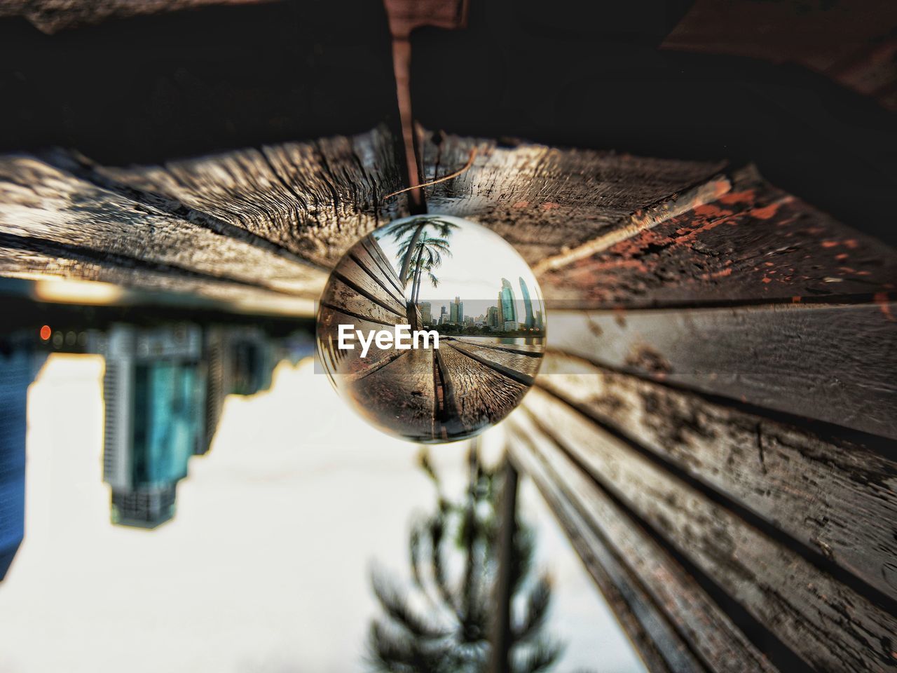 Close-up of crystal ball on wooden bench